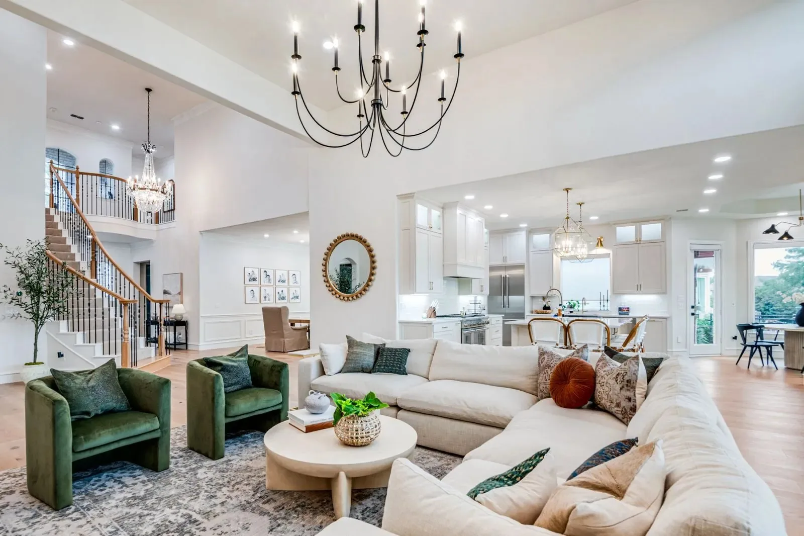 An open living room and kitchen with a two-story stair hall