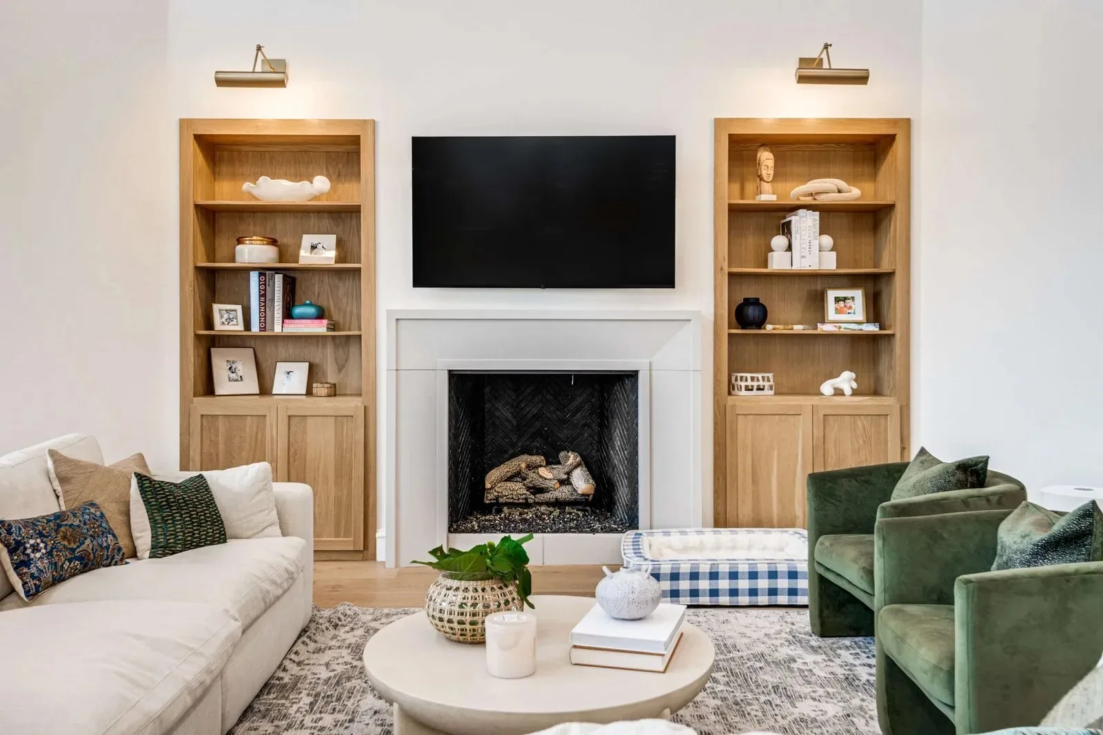 A living room with white oak built-ins flanking a fireplace